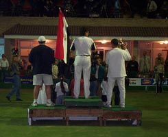 Photo of the backs of the top three players on the rostrum.